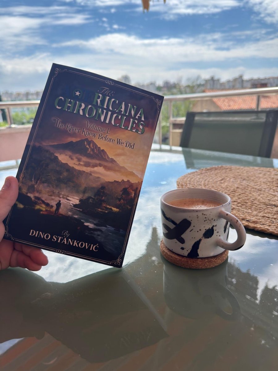 A reader holds The Americana Chronicles on a balcony in Croatia